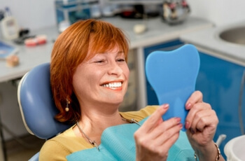 Woman smiling in mirror.