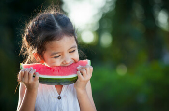 Girl eating watermelon.